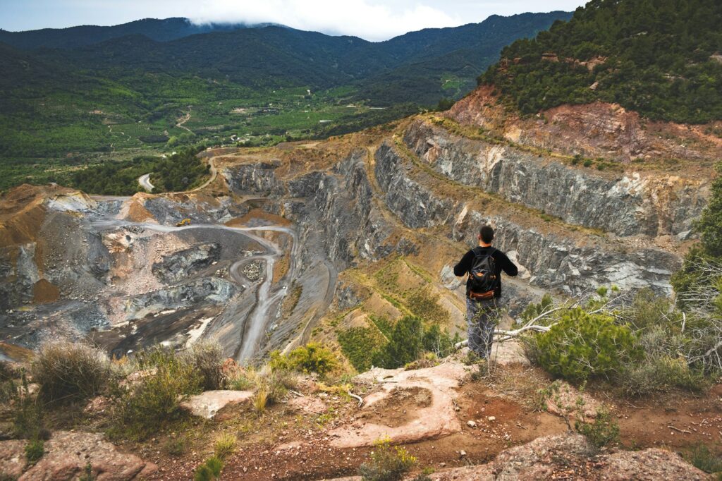 Adult man looking at a stone quarry.