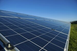 Close up of a row of solar panels in an open field. A solar farm.